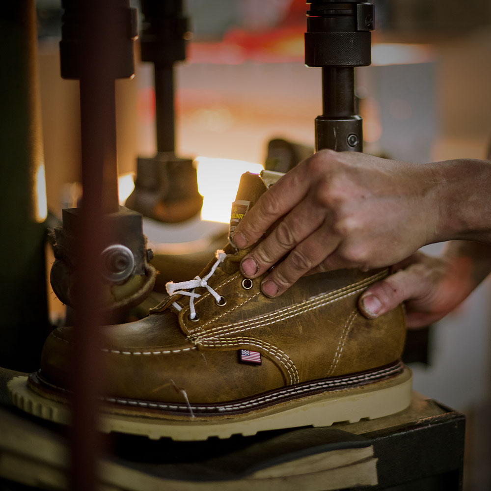 A factory worker making a Carolina boot.